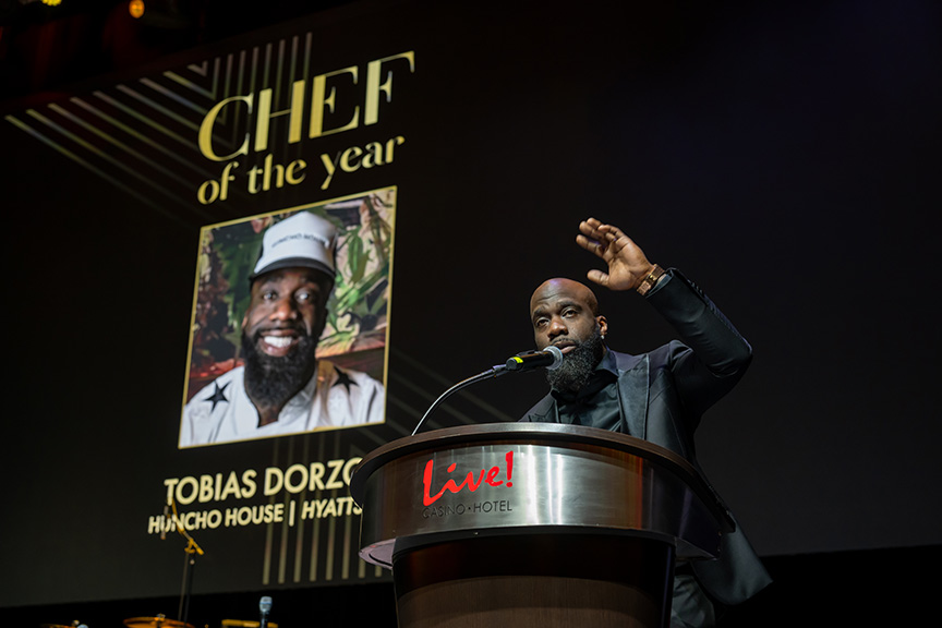 Chef of the Year, Tobias Dorzon, accepts his award on stage