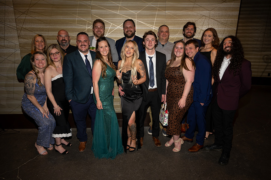 A group of people posing with Bartender of the Year, Mya Gour