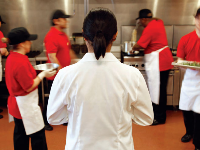 Woman chef looking into kitchen