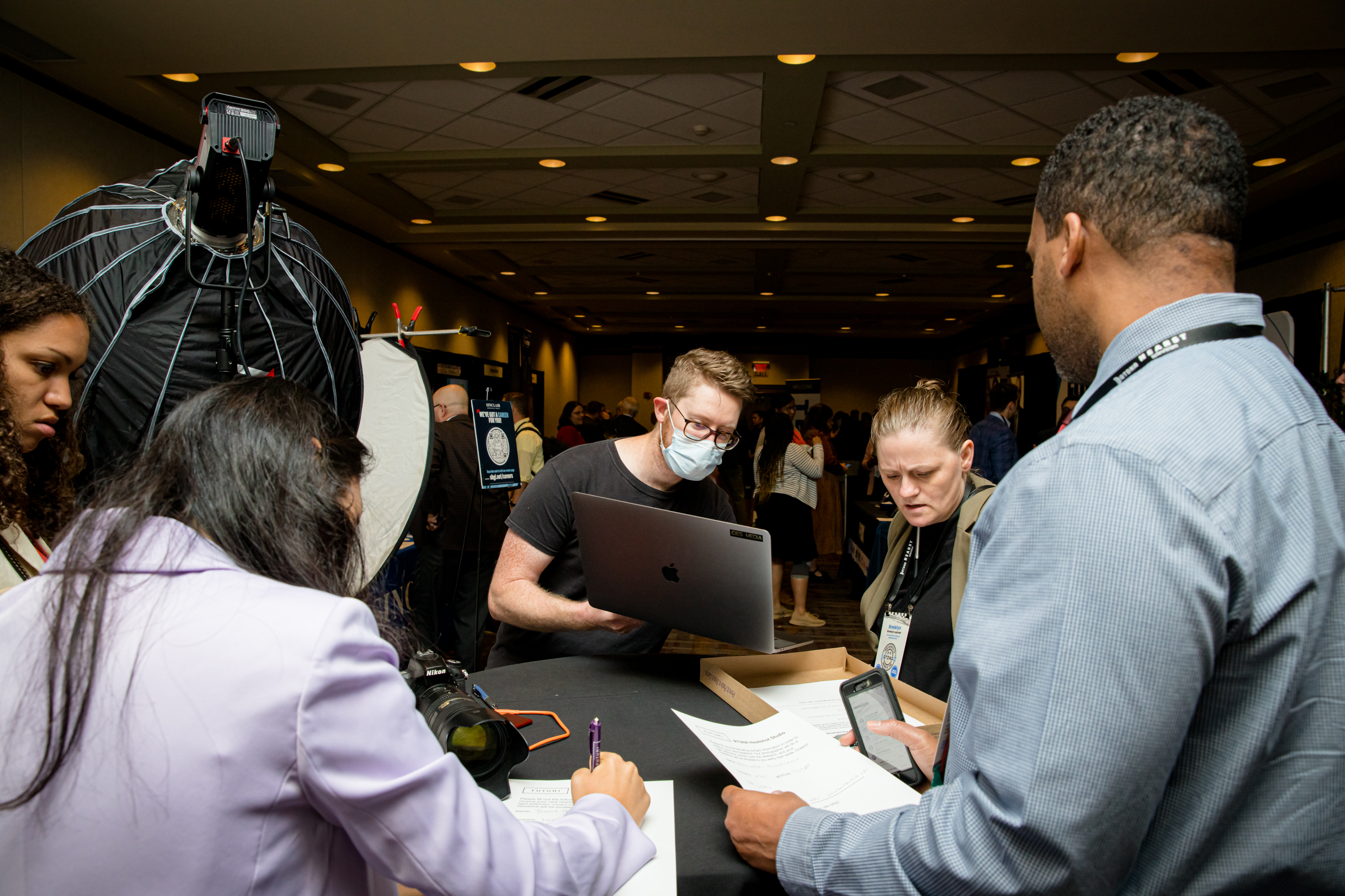 people looking at items and computer