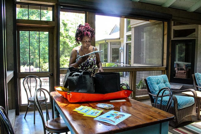 Ma'ta Crawford packs one of her small-space gardening kits in Greenville on May 16, 2024. Crawford created the kits to help families grow food in apartment complexes like she once did.