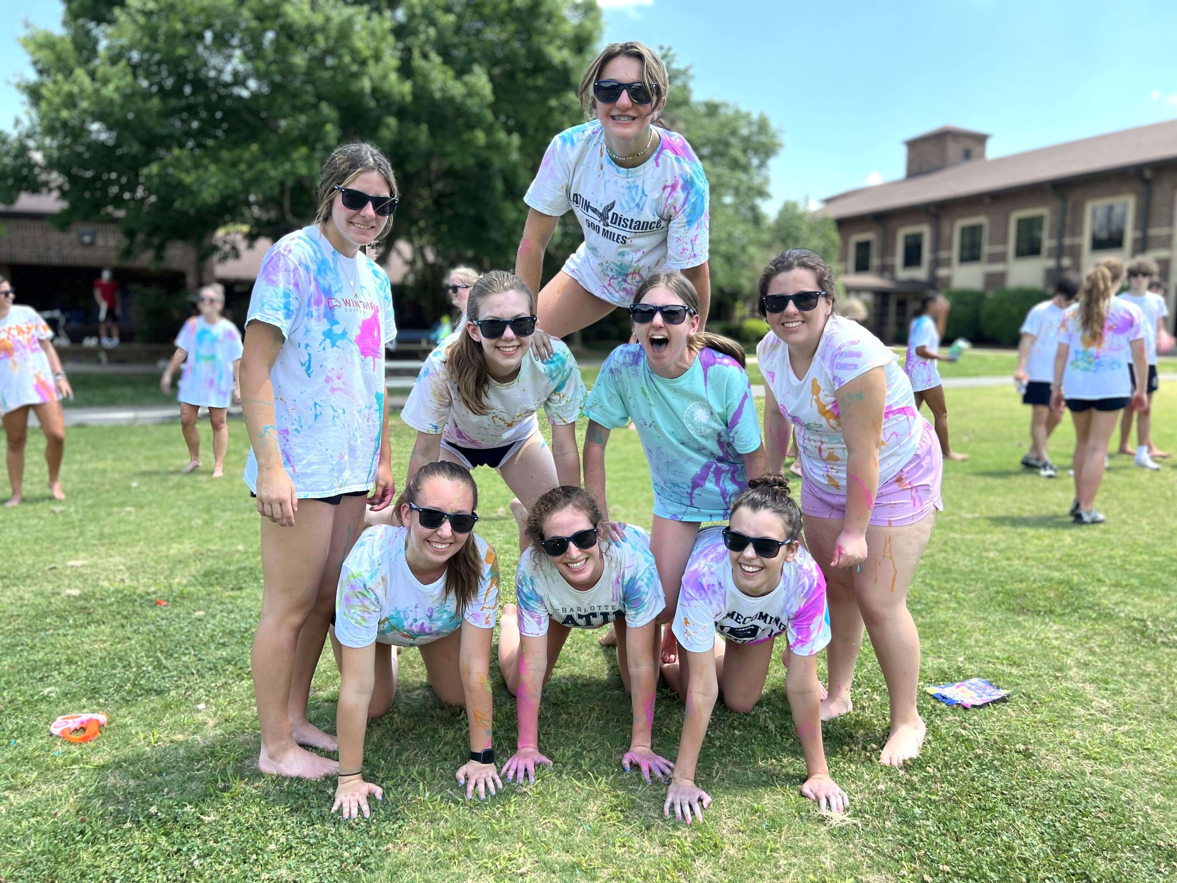 campers in a pyramid formation smiling sunglasses on