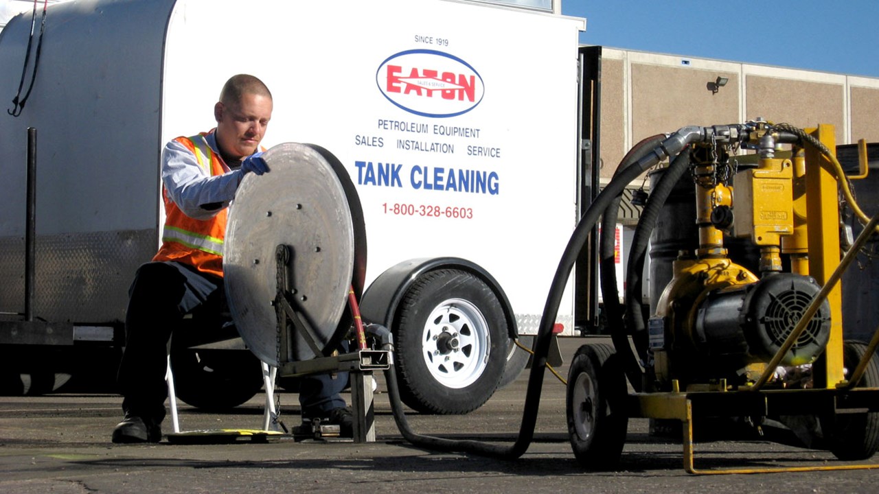 An Eaton Sales & Service technician cleaning underground fuel tanks